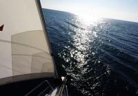 sailing yacht sailing to horizon open sea front sail bow sailboat
